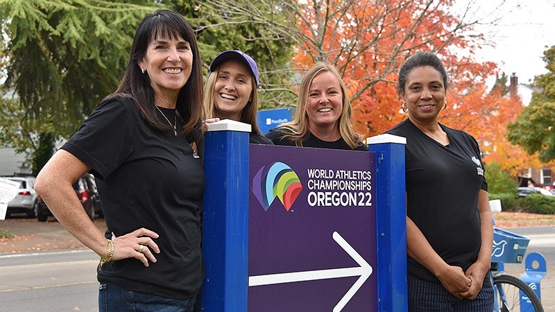 Volunteers posing by sign