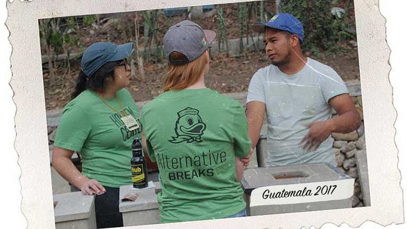 Two students talking with a stove factory worker