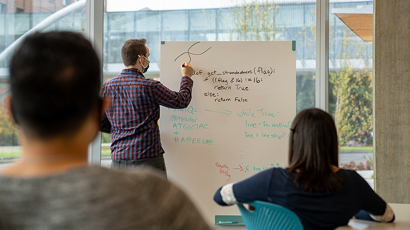 Teacher writing on whiteboard