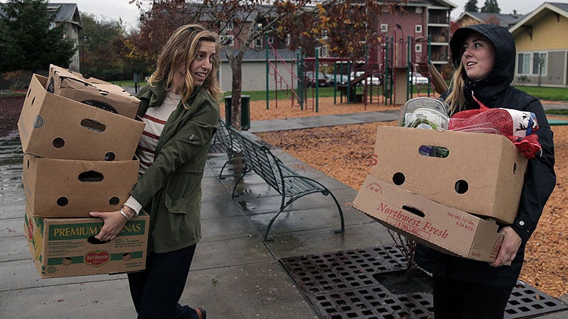 Kiara Kashuba bringing in fruits and vegetables to Willamette Gardens as part of her internship with Cornerstone Community Housing