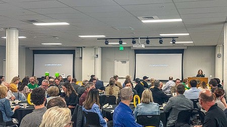 Vice President for UO Portland Jane Gordon (speaking) said it’s hard to describe the generosity of UO employees “who had very full, if not overflowing jobs before adding our campus to their work.”