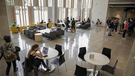 The expansive social area of the renovated EMU, with students at tables and seating
