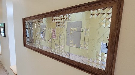 The sculpture by Garazhian includes intricately cut pieces of mirror, each shaped in the style of American quilting patterns