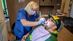 Dental clinic staff member doing an exam