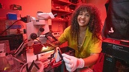 Angelique Allen at microscope in lab