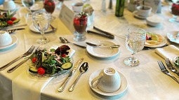 green salad and dessert with dining table place settings