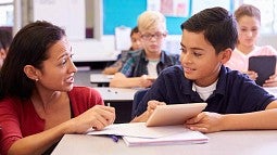 Teacher working with student