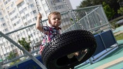 Child on tire swing