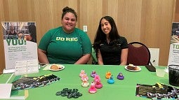 Student recreation center employees at a resource fair table