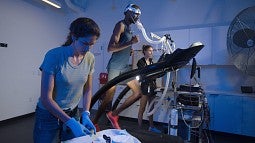 Researchers in the Bowerman Sports Science Center testing a man on a treadmill