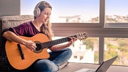 Woman learning to play guitar