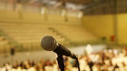 A microphone on a stand in a large rooem