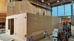 exterior of a mass plywood prototype house under construction