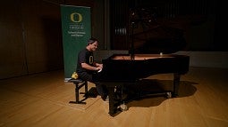 Grad student Ciro Magnani playing 'Mighty Oregon' on piano