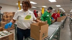 Volunteers packing food boxes at the LA Regional Food Bank. 