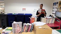 Chris Tweeter reading book in library