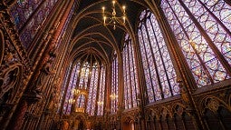 The massive arches and stained glass of a Gothic church