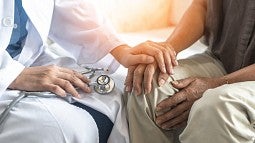 Doctor comforting a patient