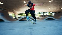 Teen doing stunts at a skateboard park