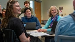 Suzanne Rowe talking with a group of students