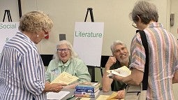 Osher Lifelong Learning Institute volunteers at table