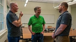 Robin Spoerl, Bob Mighell and Kent McIntosh share a laugh
