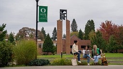 People on a bench on the UO Portland campus