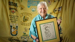 Claudine Lundgren holding a framed sketch