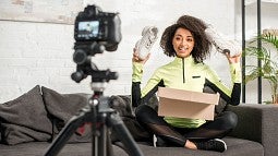 A fitness influence holding up new shoes