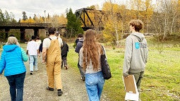 Group of students walking toward a train trestle