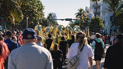People waking behind the UO marching band at a pep rally