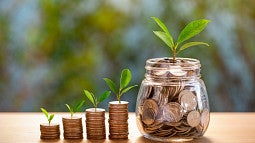 savings growth coins in jar