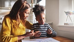 Mother and daughter working on math problems