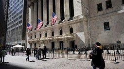 People walking in front of the New York Stock Exchange building