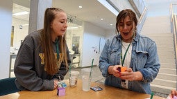 two people solve puzzle