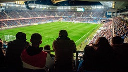 Silhouettes of a crowd at a soccer match