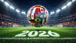 World Cup soccer ball with country flags hovers above a field
