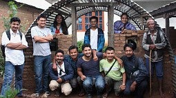 The Aashraya team with a finished emergency shelter