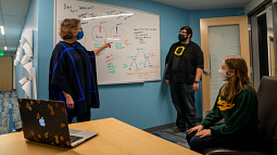 Faculty members at whiteboard discussing story plan