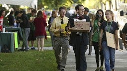 UO President Michael Schill lends a hand during Unpack the Quack