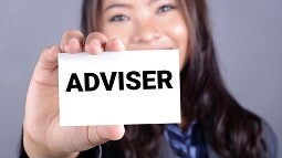 College adviser holding a placard