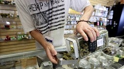 Image shows activity at an Oregon retail marijuana business (Anna Reed, Statesman Journal, via AP)