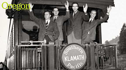 Four members of the 1938-39 University of Oregon basketball team, known as the Tall Firs, waving from the rear platform of a train as they depart Eugene for the 1939 NCAA basketball tournament's West regional held in San Francisco.