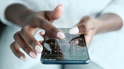 Woman playing soduku on phone