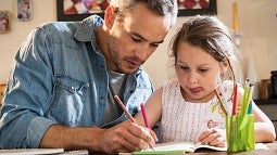 Man helping child with homework