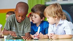 Three children working at desk