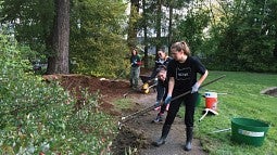 Students on park cleanup duty during a day of service last year