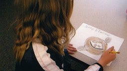 Child drawing a bird's nest