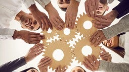 People holding cogwheels