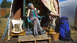  Jourdan Horton outside a Conestoga hut temporary shelter